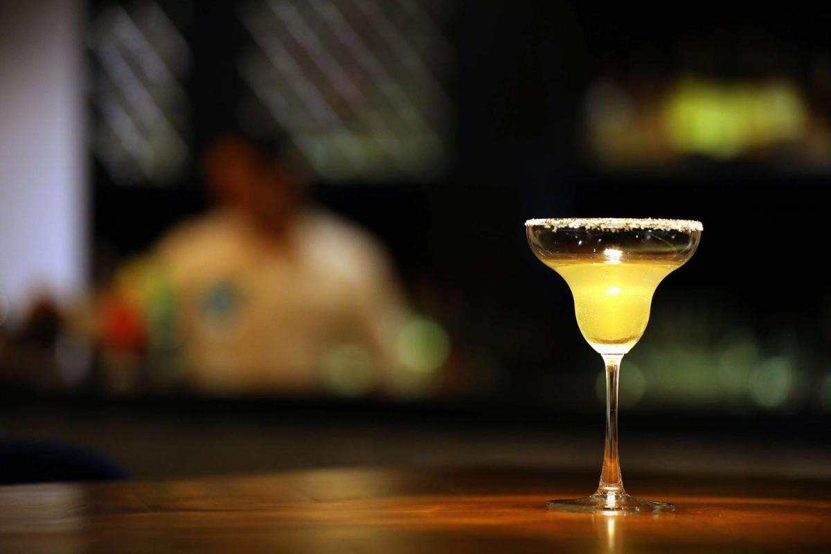 a glass of wine sitting on a table at Hyatt Regency Amritsar Hotel & Spa in Amritsar
