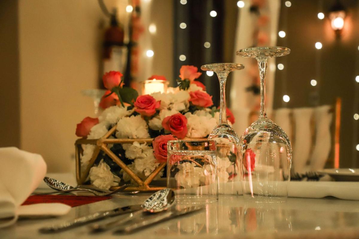 a table with wine glasses and flowers on it at Hyatt Regency Amritsar Hotel & Spa in Amritsar