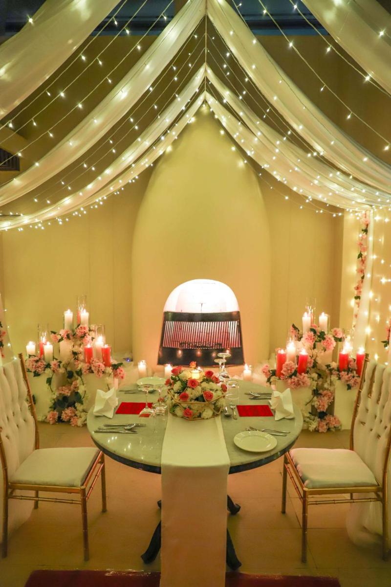 a dining room with a table and chairs and lights at Hyatt Regency Amritsar Hotel & Spa in Amritsar