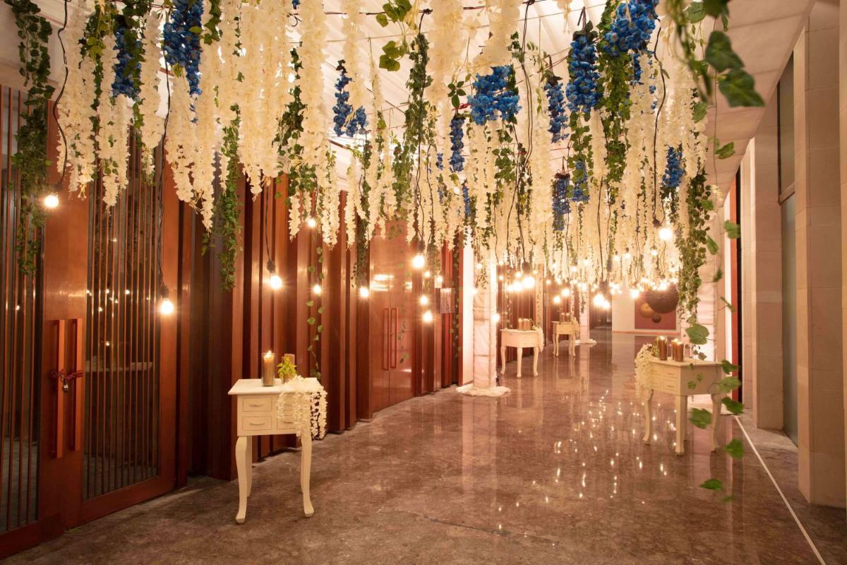 a room with lights and flowers hanging from a ceiling at Hyatt Regency Amritsar Hotel & Spa in Amritsar