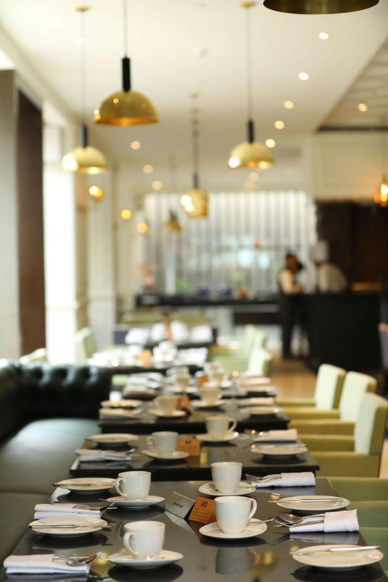 a long table with cups and saucers on it at Hyatt Regency Amritsar Hotel & Spa in Amritsar