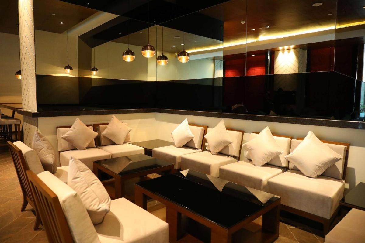 a waiting room with white couches and a table at Hyatt Regency Amritsar Hotel & Spa in Amritsar