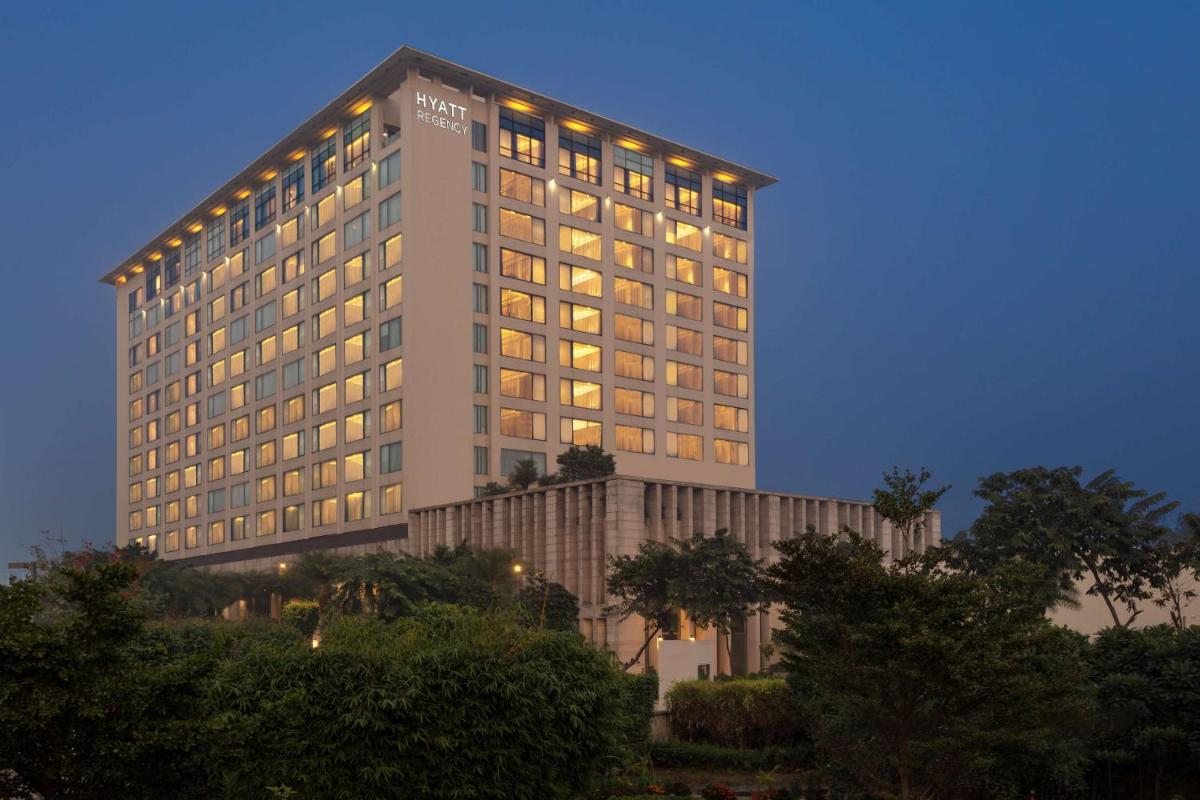 a tall hotel building with lights on at Hyatt Regency Amritsar Hotel & Spa in Amritsar