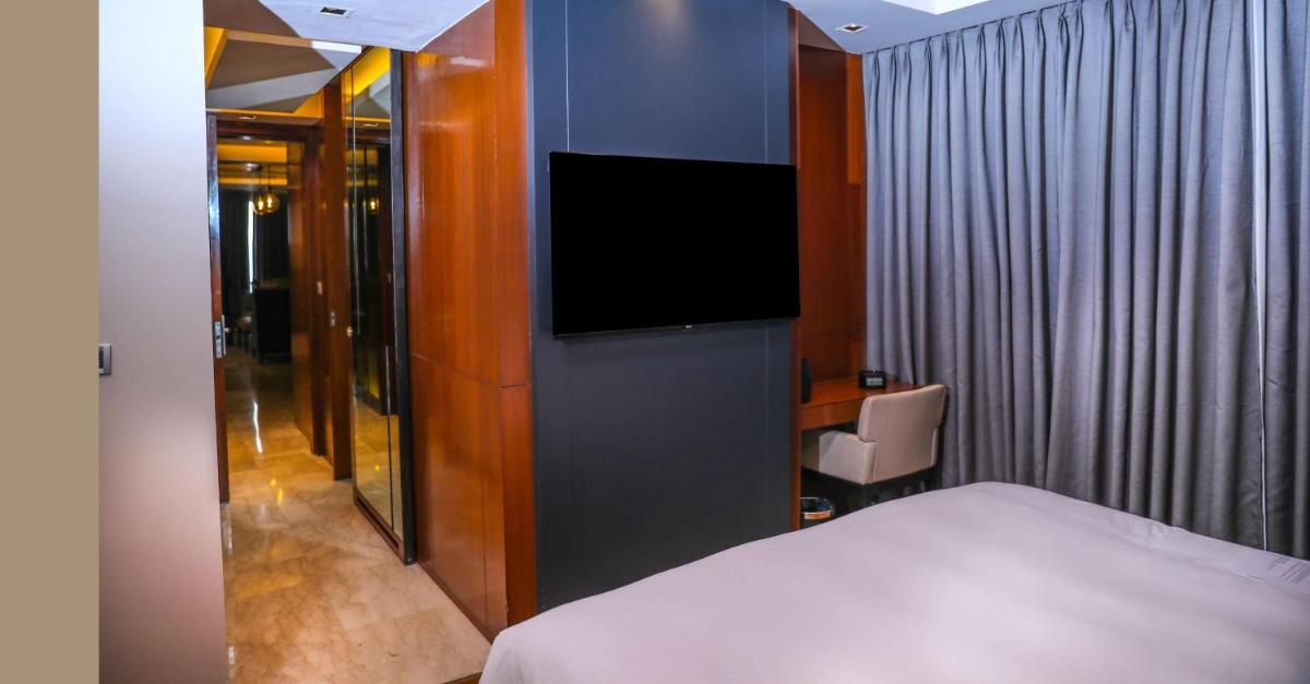 a hotel room with a bed and a tv at Hyatt Regency Amritsar Hotel & Spa in Amritsar