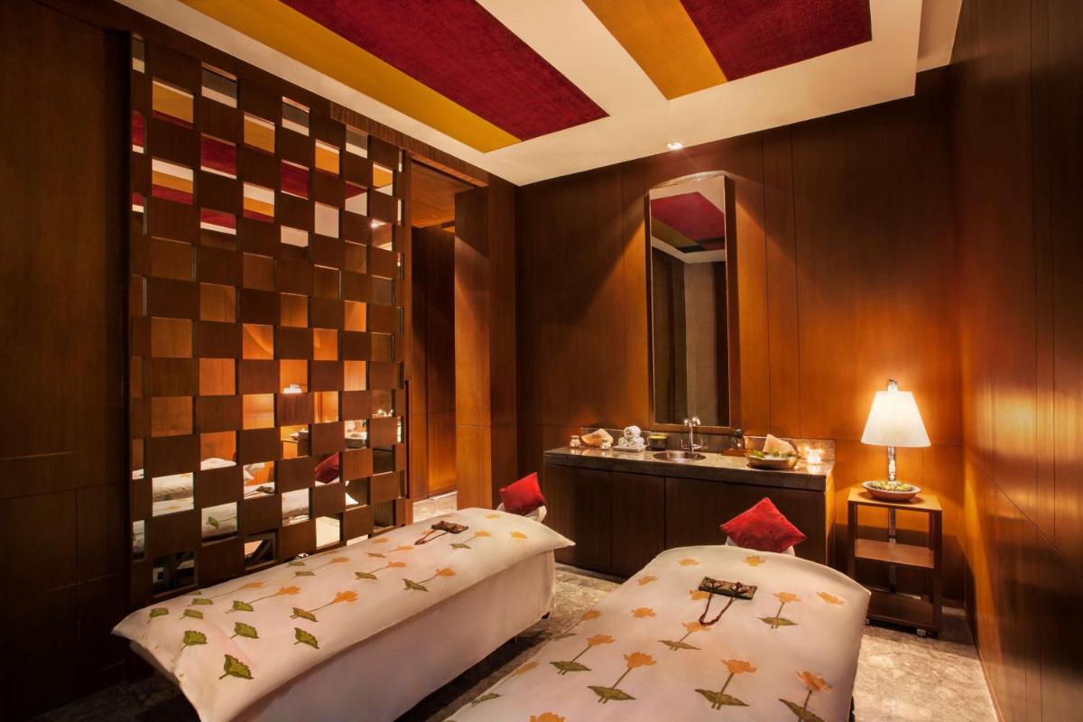 a bathroom with two beds and a sink in it at Hyatt Regency Amritsar Hotel & Spa in Amritsar
