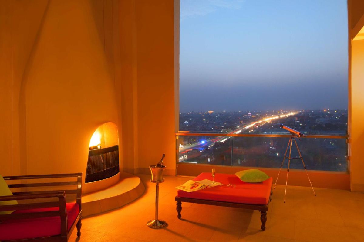 a room with a large window with a view of a city at Hyatt Regency Amritsar Hotel & Spa in Amritsar