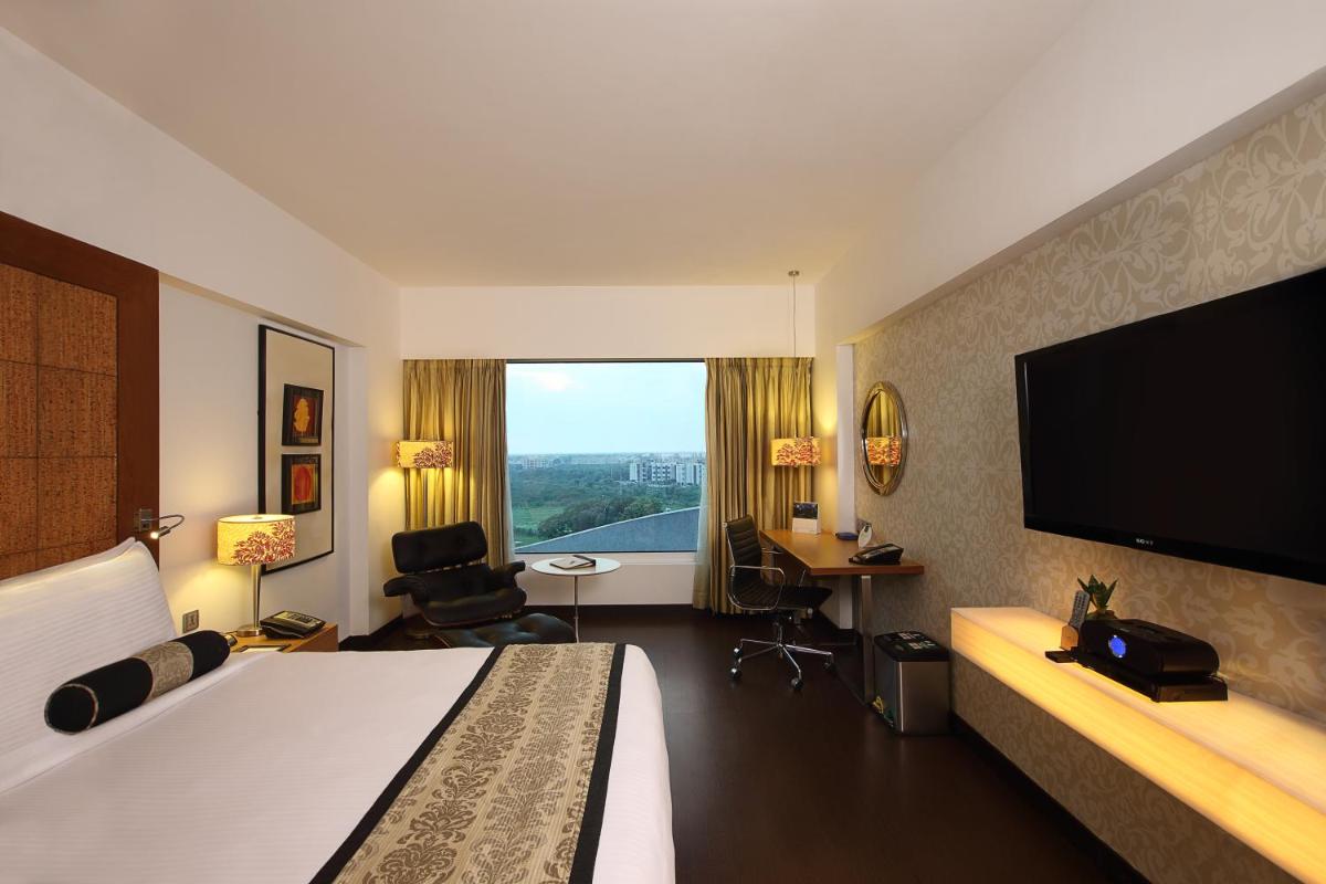 a hotel room with a bed and a flat screen tv at Fortune Select SG Highway, Ahmedabad - Member ITC Hotels' Group in Ahmedabad