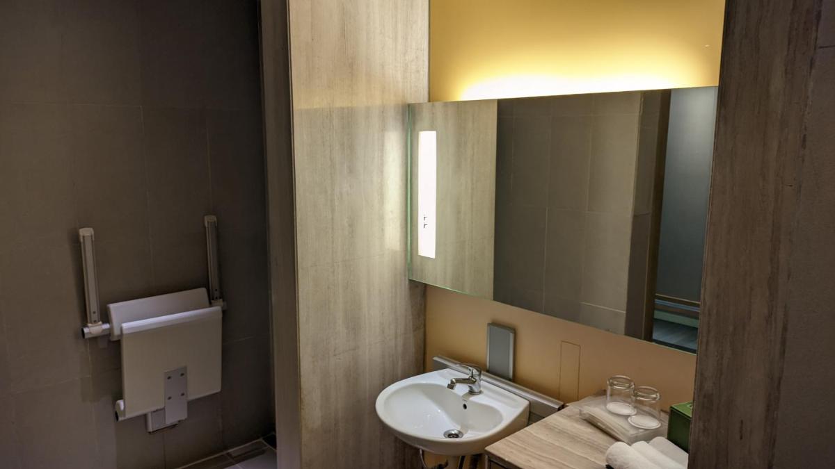 a bathroom with a sink and a mirror at Holiday Inn New Delhi Aerocity by IHG in New Delhi