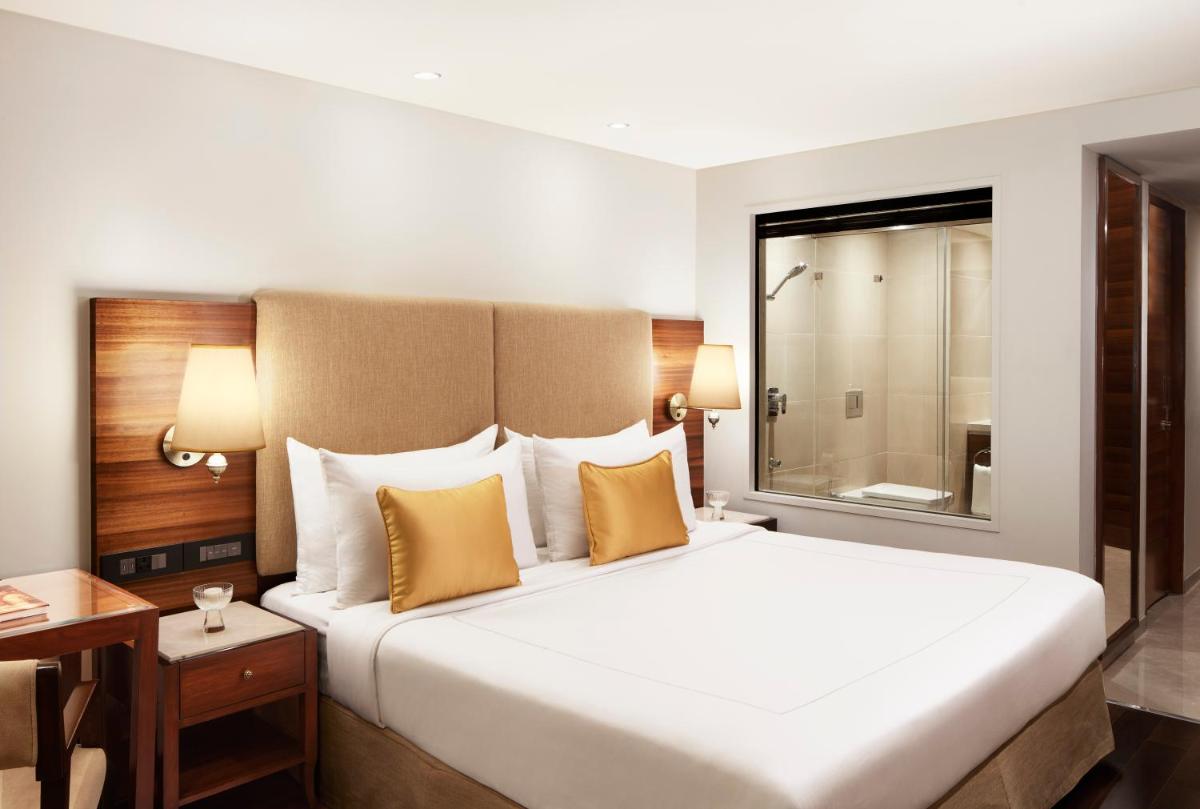 a hotel room with a large bed and a window at President - IHCL SeleQtions in Mumbai
