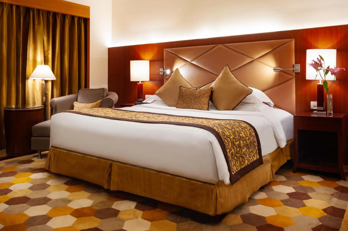 a bedroom with a large bed in a hotel room at Taj Chandigarh in Chandīgarh