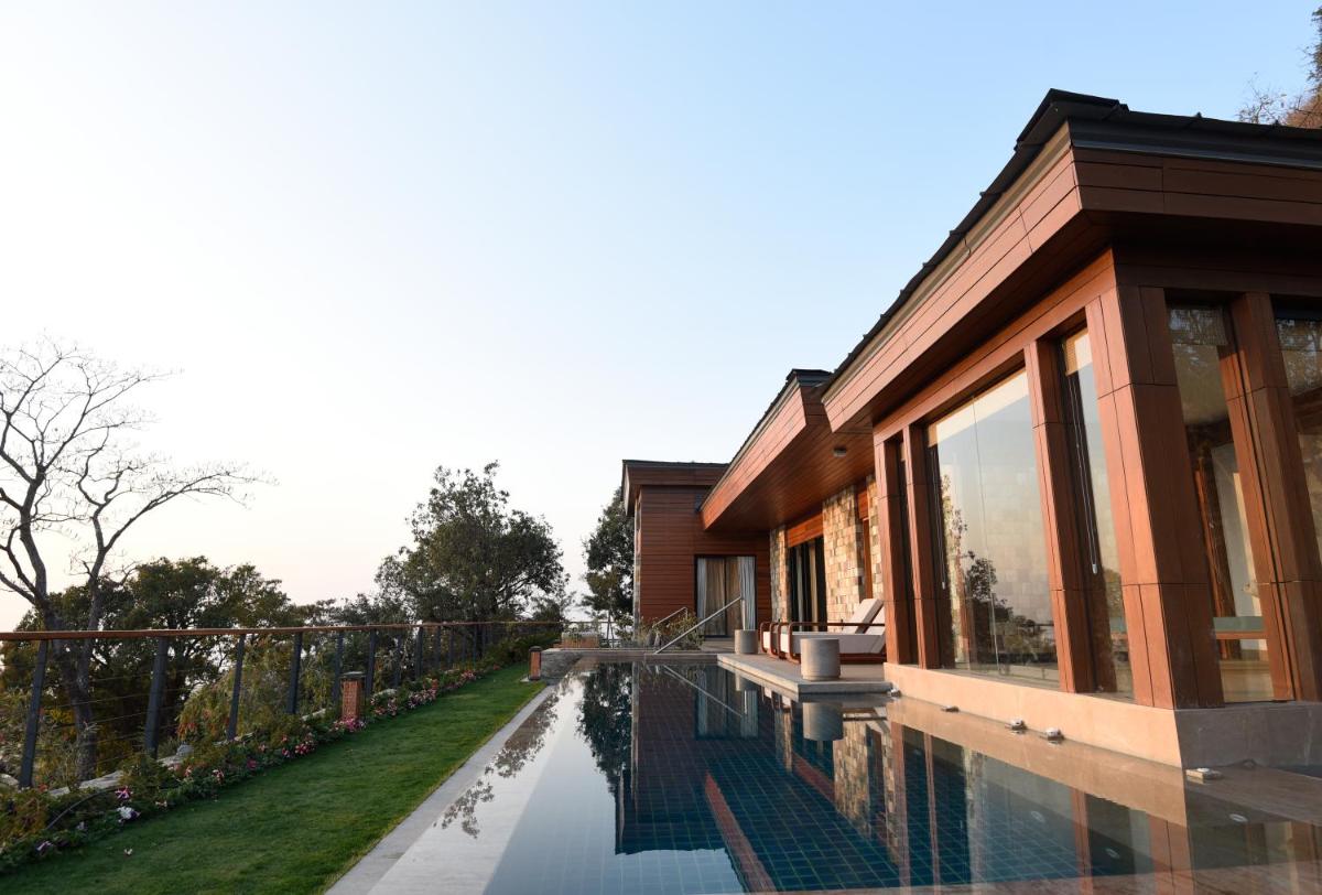 a house with a swimming pool in front of it at The Westin Resort & Spa Himalayas in Rishīkesh