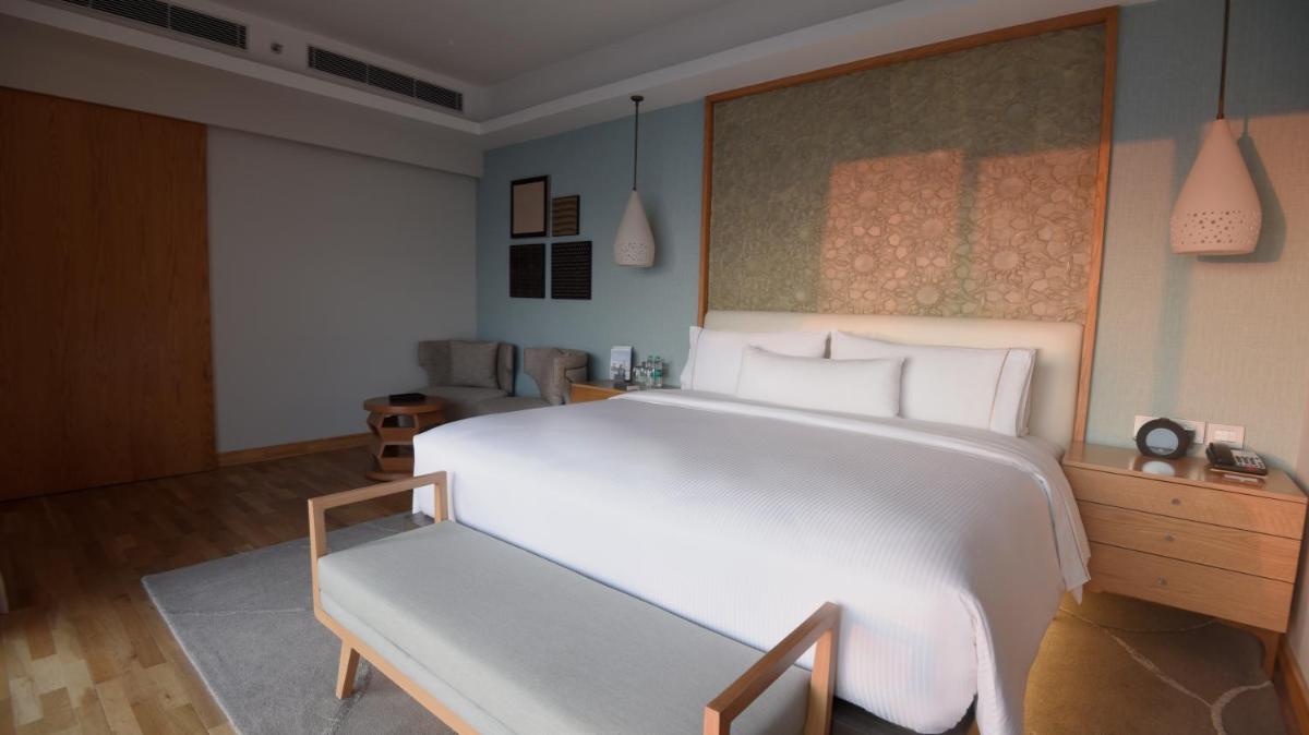 a bedroom with a large white bed in it at The Westin Resort & Spa Himalayas in Rishīkesh