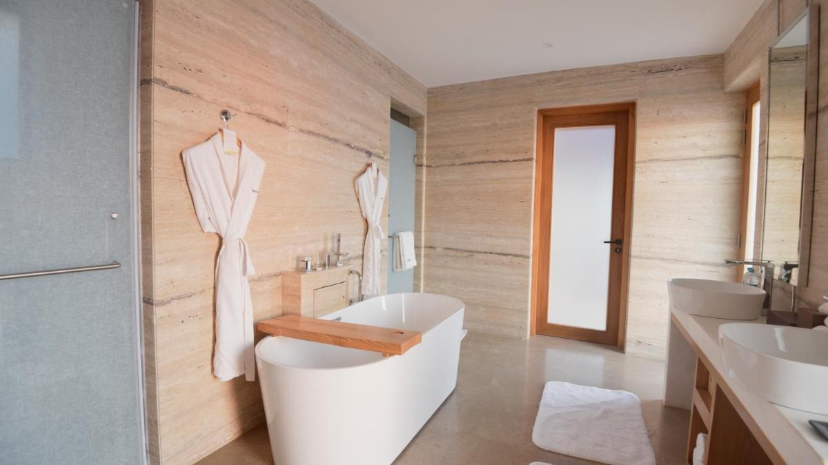 a bathroom with a white tub and two sinks at The Westin Resort & Spa Himalayas in Rishīkesh