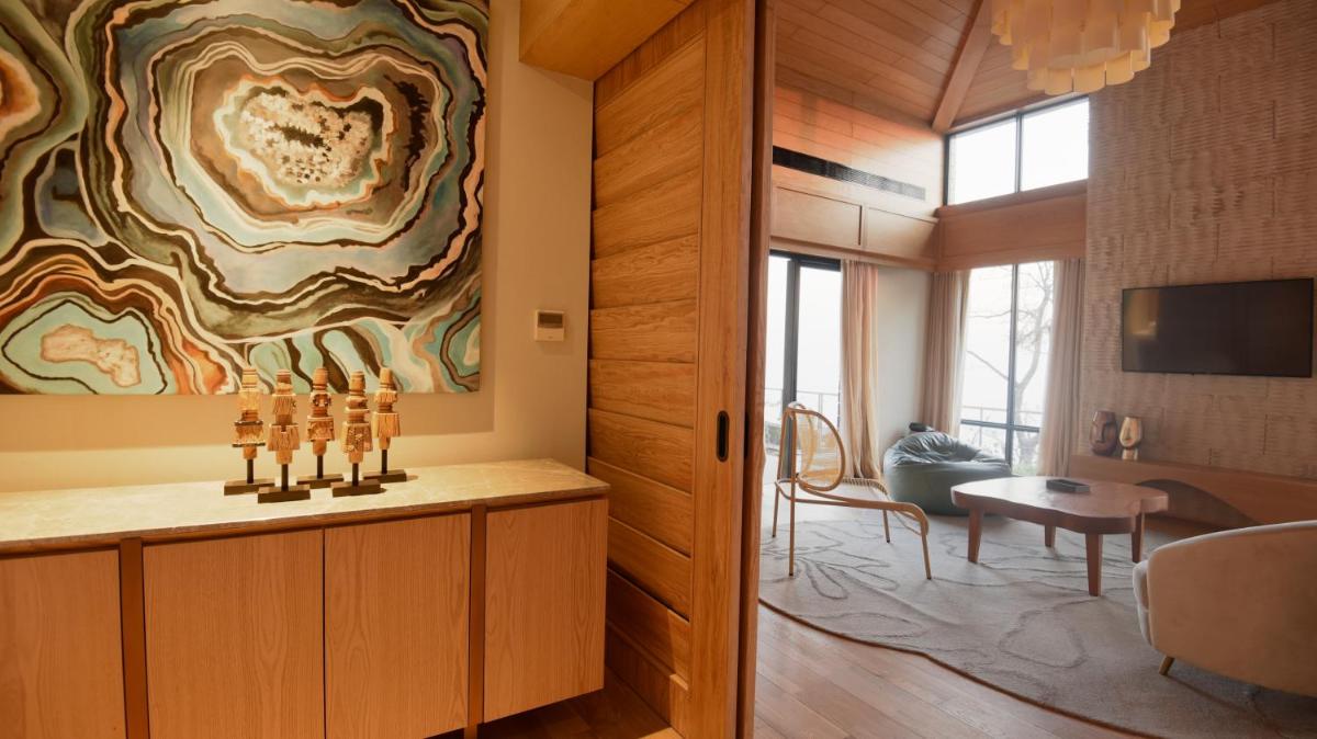 a living room with a large painting on the wall at The Westin Resort & Spa Himalayas in Rishīkesh