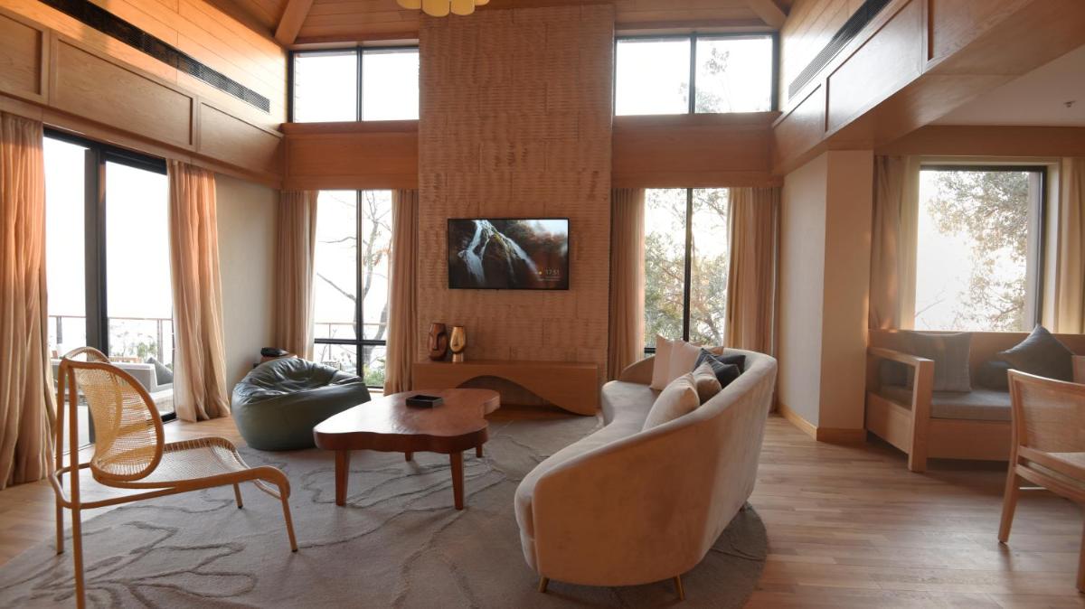 a living room with a couch and chairs and windows at The Westin Resort & Spa Himalayas in Rishīkesh