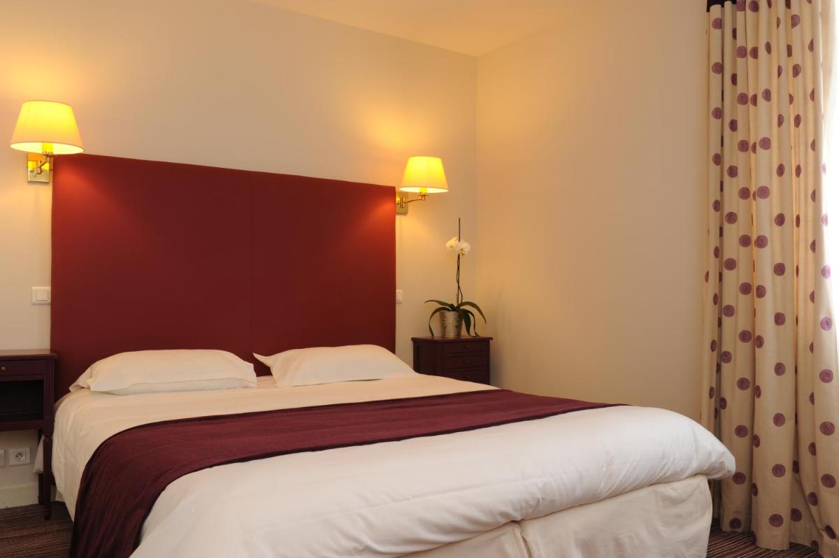 Un ou plusieurs lits dans un hébergement de l'établissement Hôtel Lutétia & Spa
