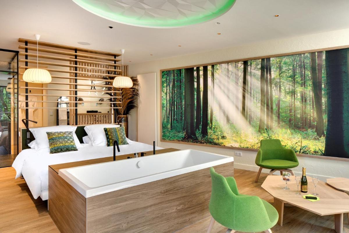 Un ou plusieurs lits dans un hébergement de l'établissement LA CHENEAUDIÈRE - Hôtel Spa - Relais & Châteaux - Restaurant étoilé