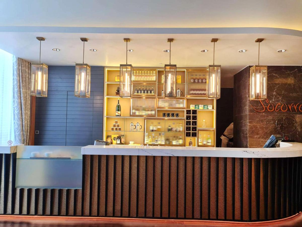 a bar in a restaurant with a counter at InterContinental Jaipur Tonk Road by IHG in Jaipur