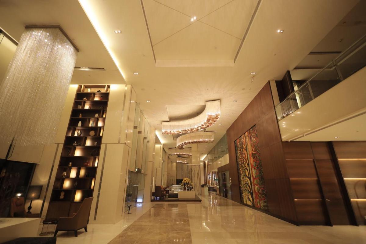a hallway of a building with a large lobby at Holiday Inn Mumbai International Airport by IHG in Mumbai