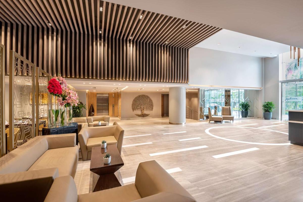 a lobby of a hotel with couches and chairs at Radisson Hotel Sector 29 Gurugram in Gurgaon