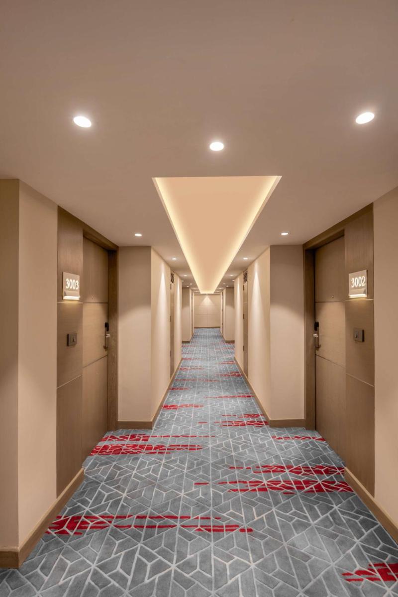 a hallway of a hotel with a long hallway of a corridorngthngthngthngth at Radisson Hotel Sector 29 Gurugram in Gurgaon