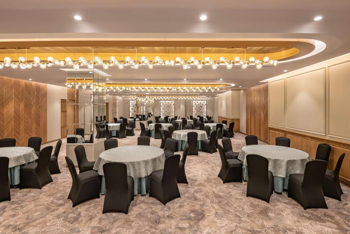 a ballroom with tables and chairs in a room at Radisson Hotel Sector 29 Gurugram in Gurgaon