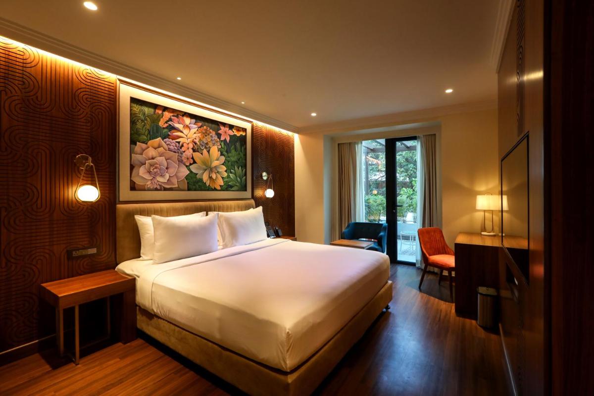a bedroom with a large white bed in a room at Radisson Blu Hotel & Suites GRT Chennai in Chennai