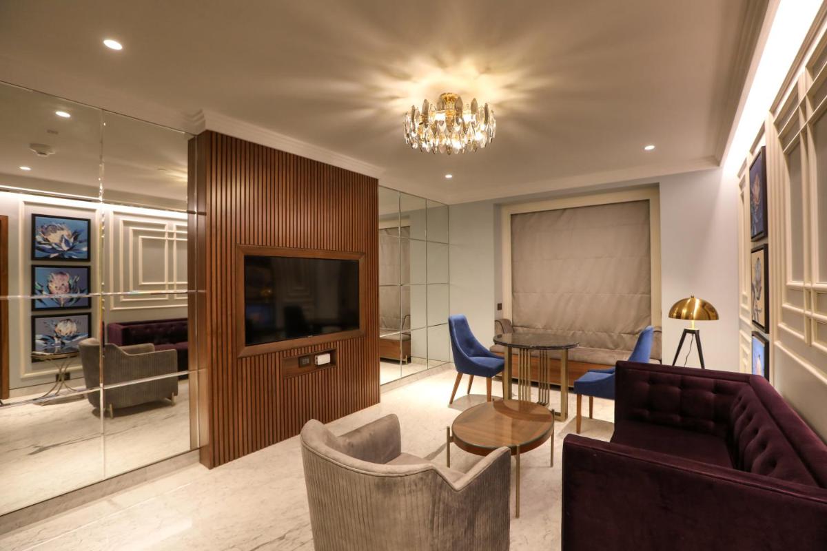 a living room with a couch and a table at Radisson Blu Hotel & Suites GRT Chennai in Chennai