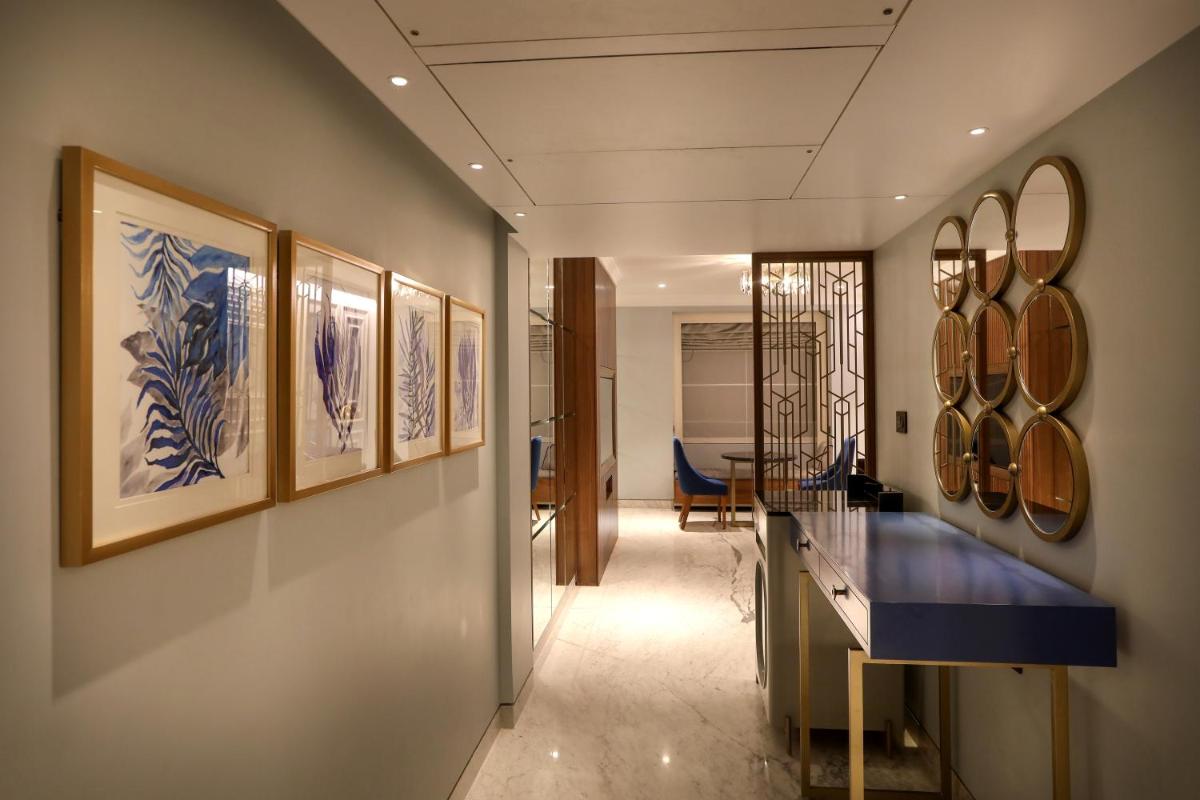 a hallway with blue and white paintings on the wall at Radisson Blu Hotel & Suites GRT Chennai in Chennai