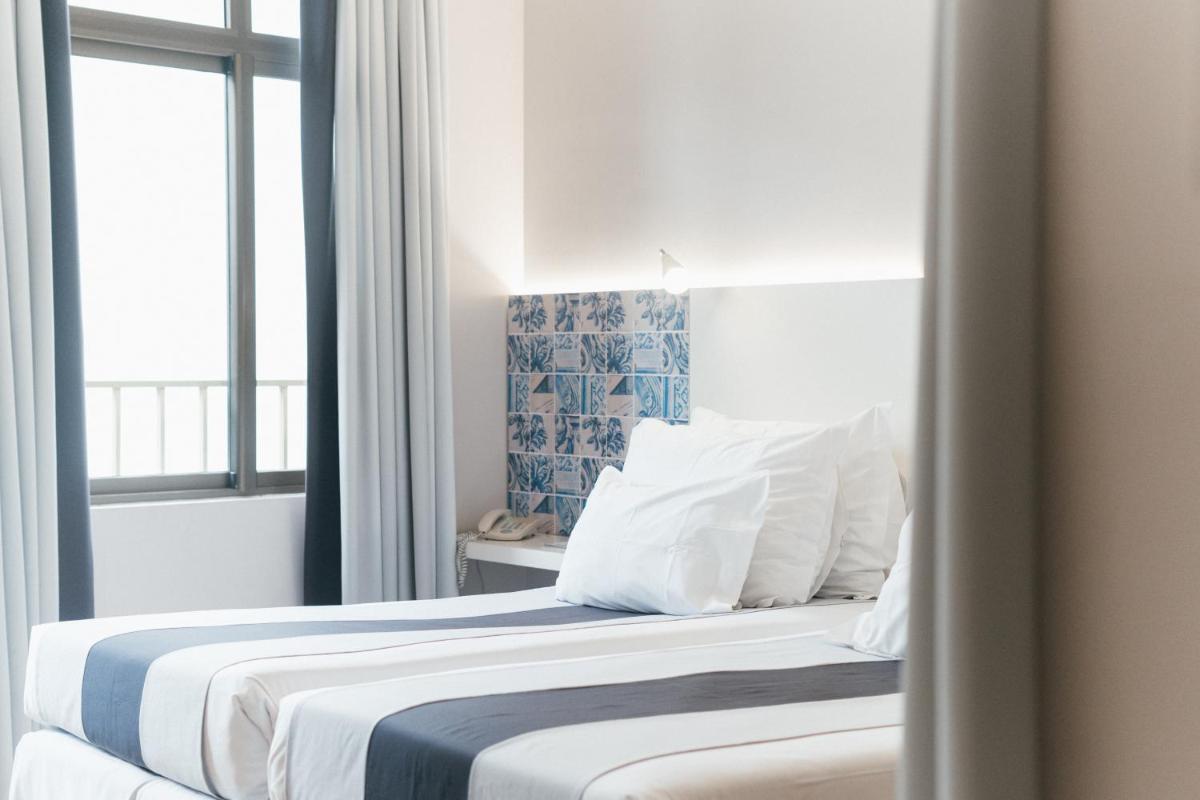 Uma cama ou camas num quarto em Sé Boutique Hotel
