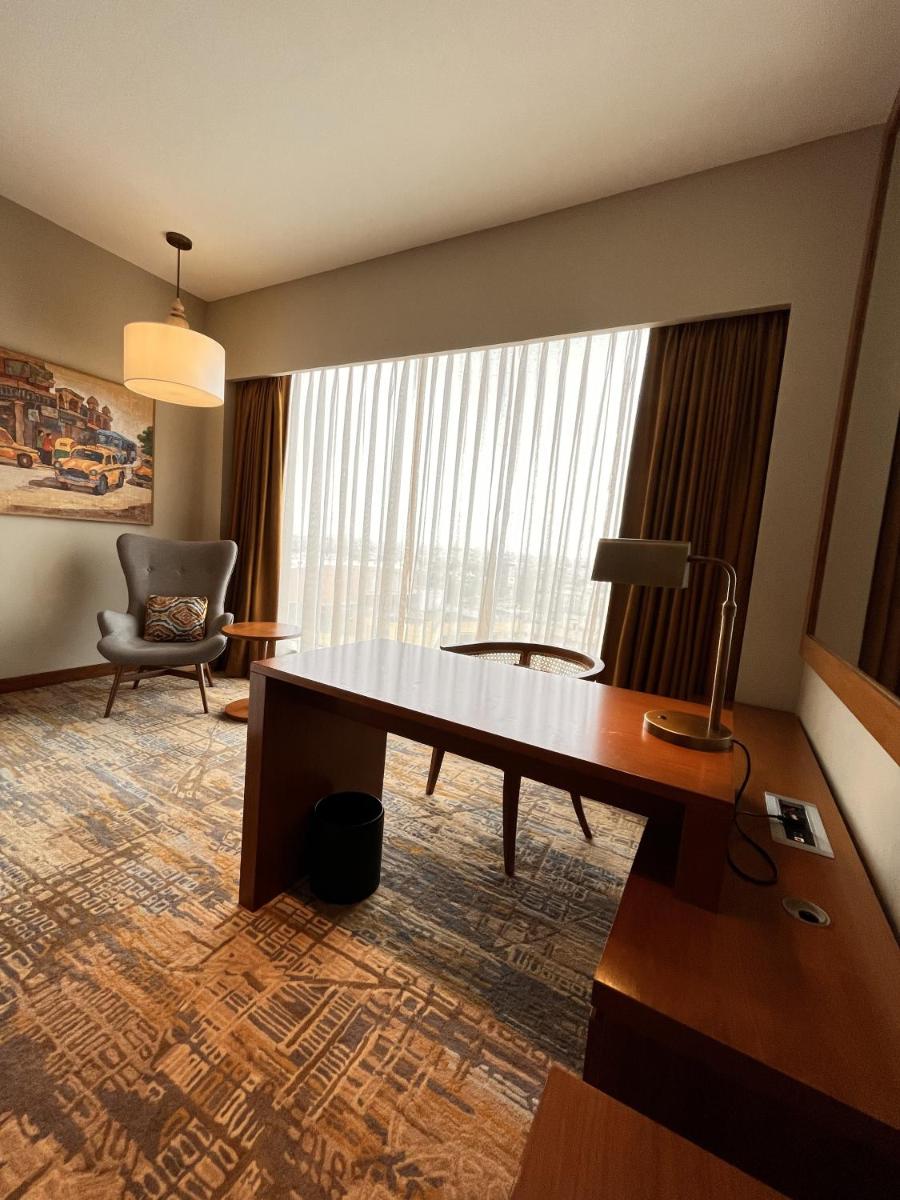 a hotel room with a desk and a chair at Taj City Centre New Town, Kolkata in Kolkata a hotel room with a desk and a chair at Taj City Centre New Town, Kolkata in Kolkata