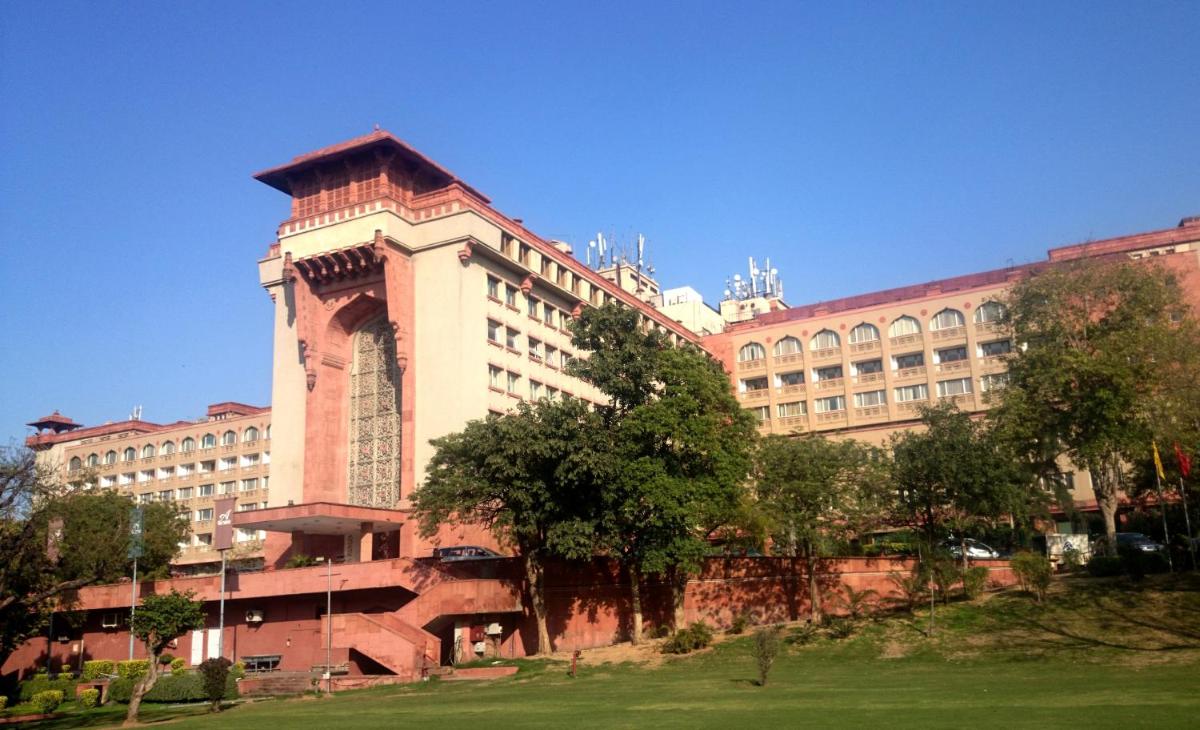 a large building with a clock tower in front of it at The Ashok, New Delhi in New Delhi a large building with a clock tower in front of it at The Ashok, New Delhi in New Delhi