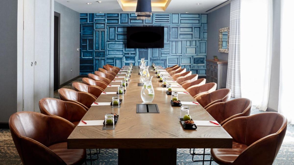 a long conference room with a long table and chairs at Holiday Inn Goa Candolim in Candolim a long conference room with a long table and chairs at Holiday Inn Goa Candolim in Candolim