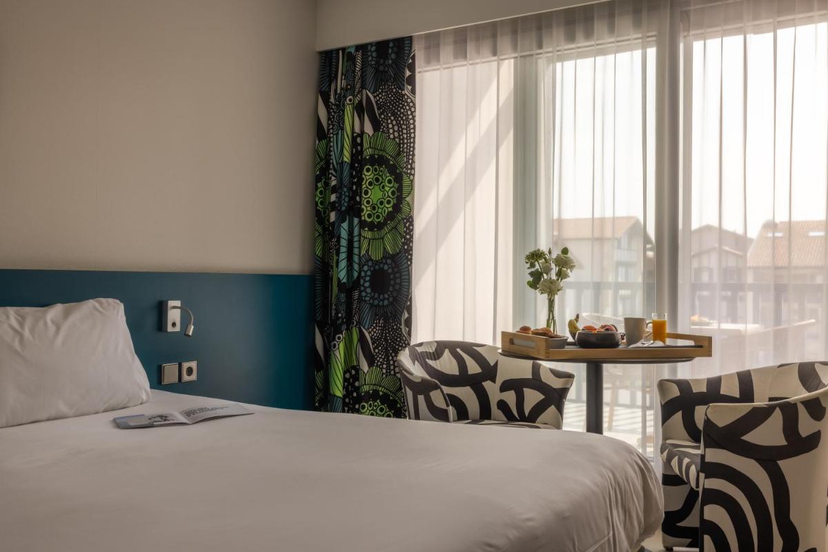 Un ou plusieurs lits dans un hébergement de l'établissement Hôtel Serge Blanco - Relais Thalasso & Spa