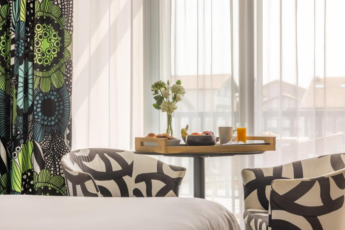 Un ou plusieurs lits dans un hébergement de l'établissement Hôtel Serge Blanco - Relais Thalasso & Spa
