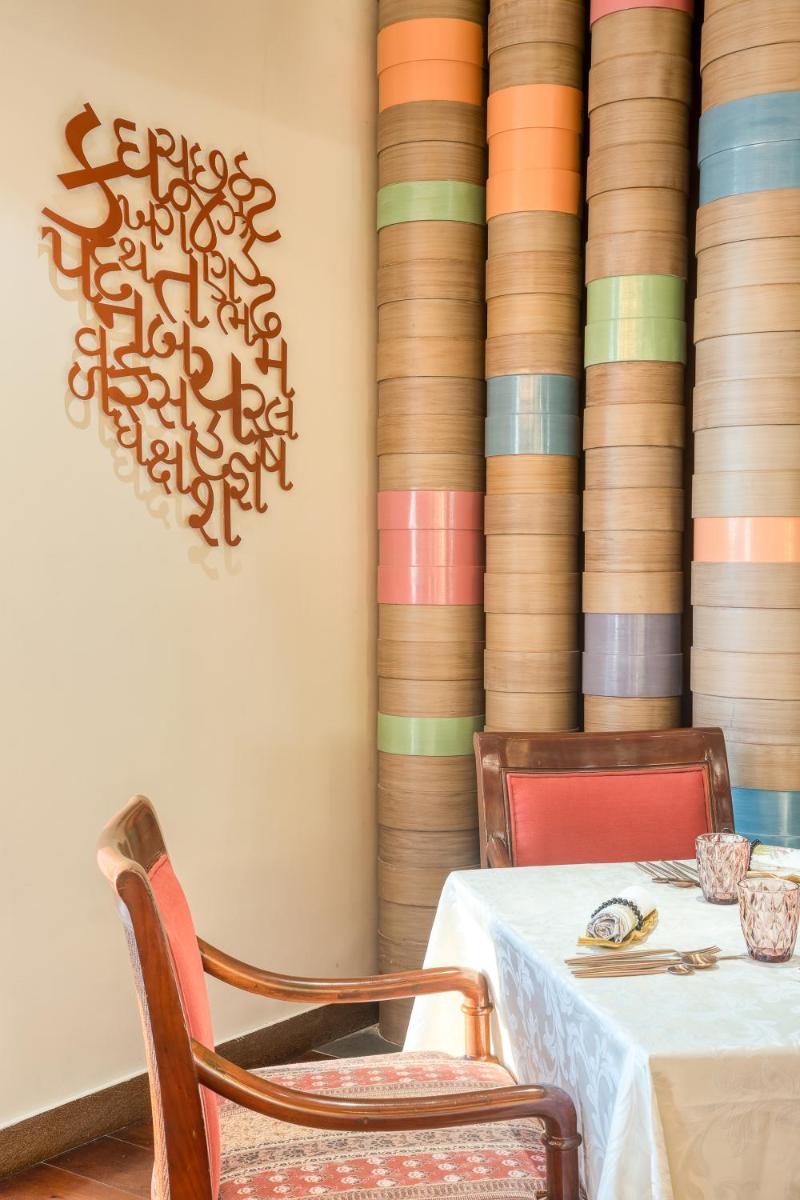 a dining room with a table and two chairs at Hyatt Regency Ahmedabad in Ahmedabad