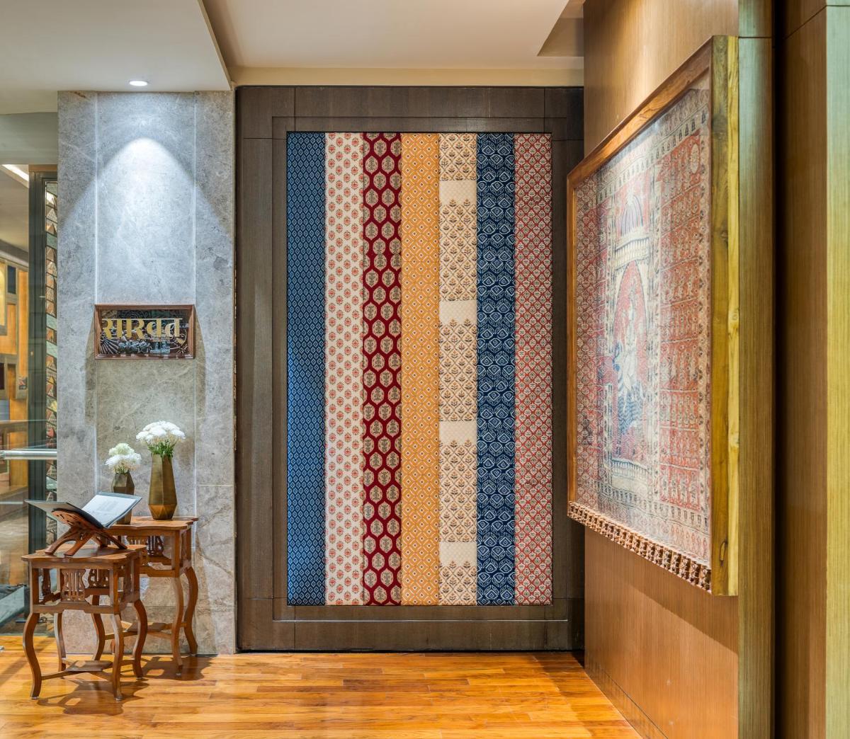 a room with a wall with a painting on it at Hyatt Regency Ahmedabad in Ahmedabad