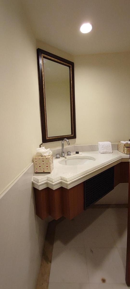 a bathroom with a sink and a mirror at Taj Bengal in Kolkata