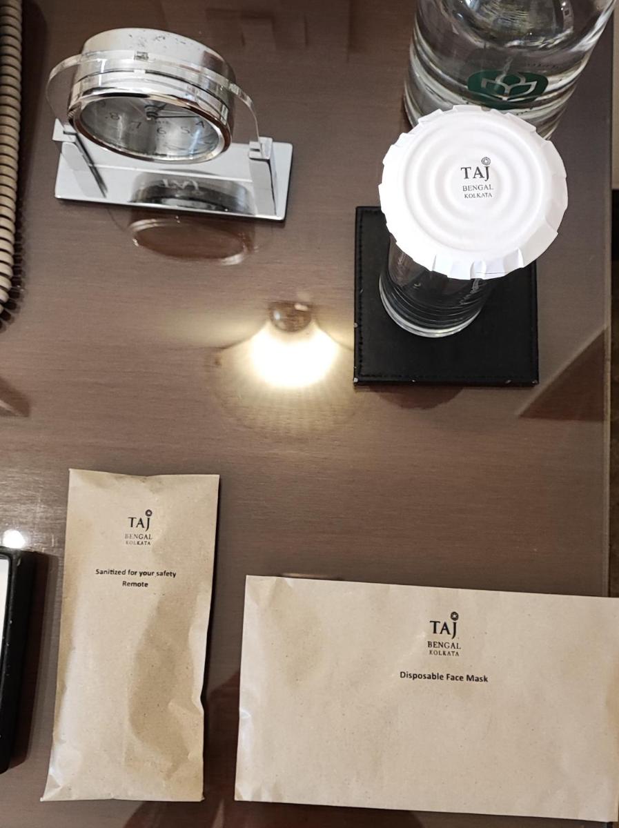 a table with two cups and a light and some receipts at Taj Bengal in Kolkata