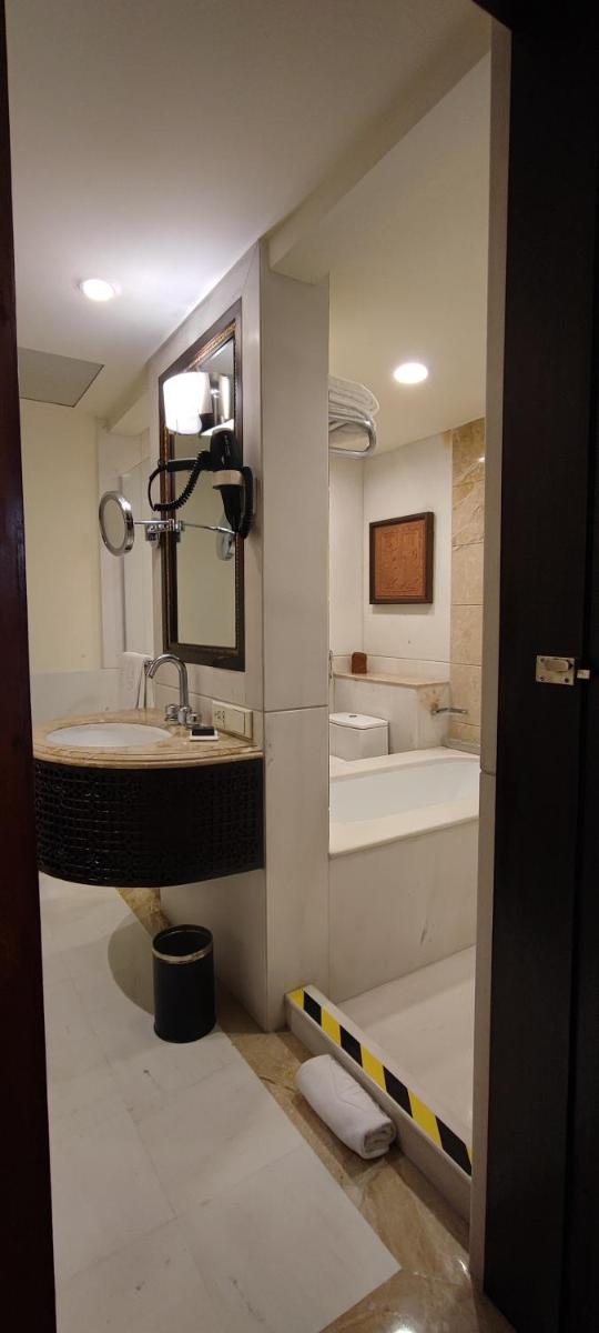a bathroom with a sink and a tub at Taj Bengal in Kolkata