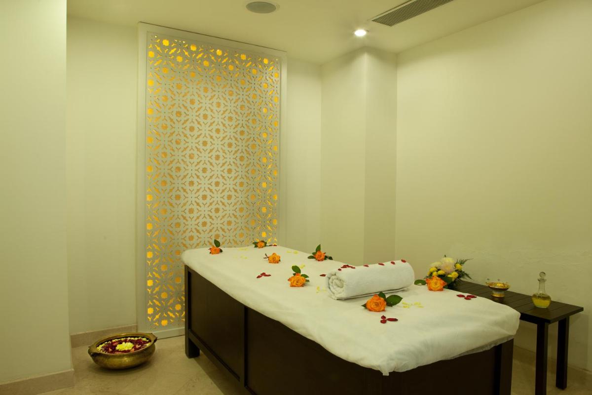 a bed with pumpkins on it in a room at Lemon Tree Premier, Delhi Airport in New Delhi a bed with pumpkins on it in a room at Lemon Tree Premier, Delhi Airport in New Delhi
