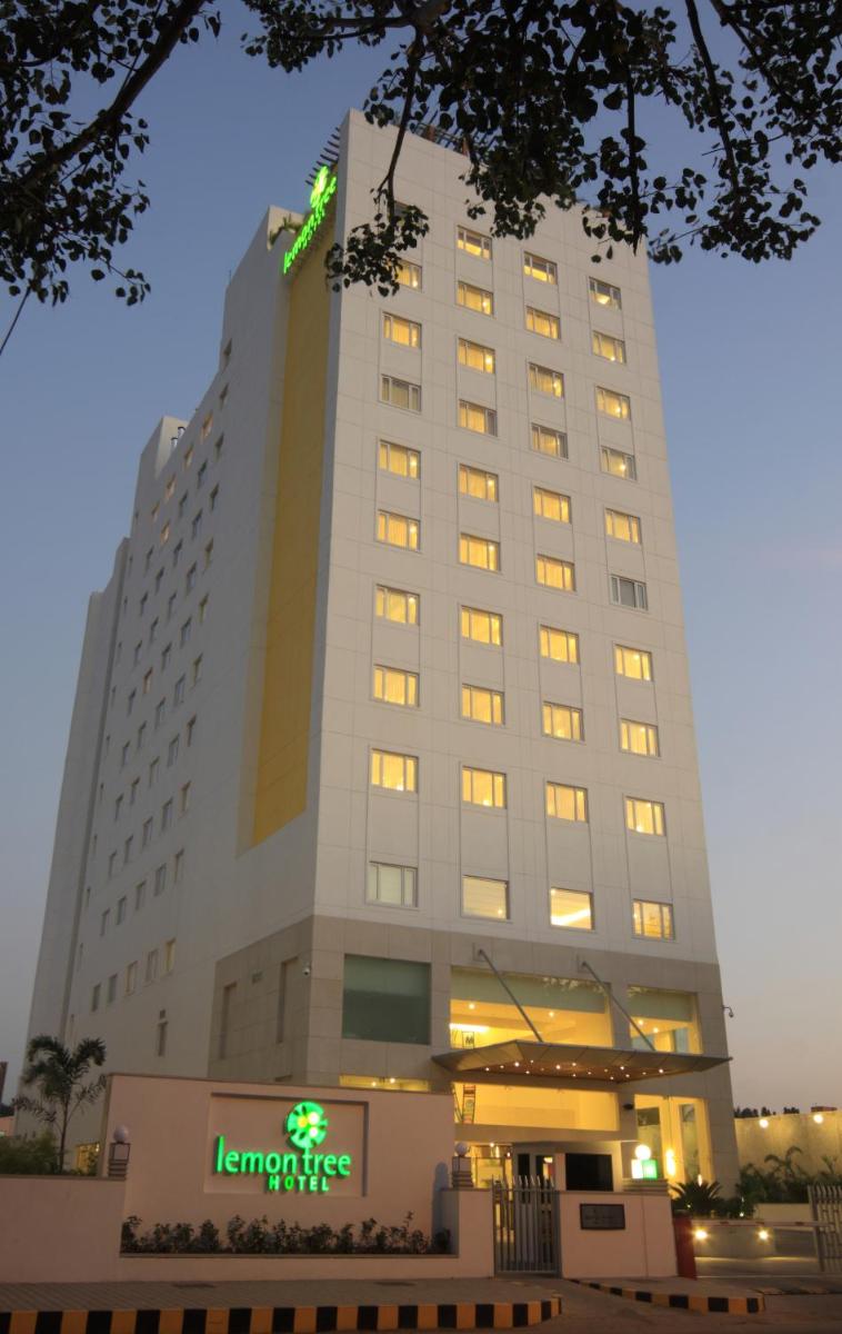 a large hotel building with a sign on it at Lemon Tree Premier, Ulsoor Lake, Bengaluru in Bengaluru