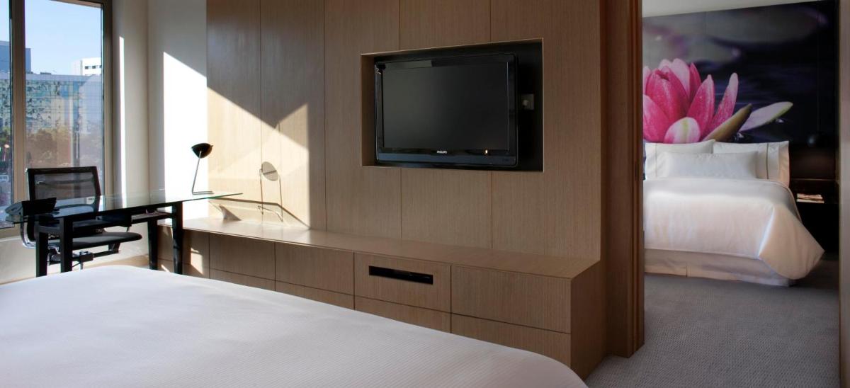 a hotel room with a bed and a television at The Westin Hyderabad Mindspace in Hyderabad