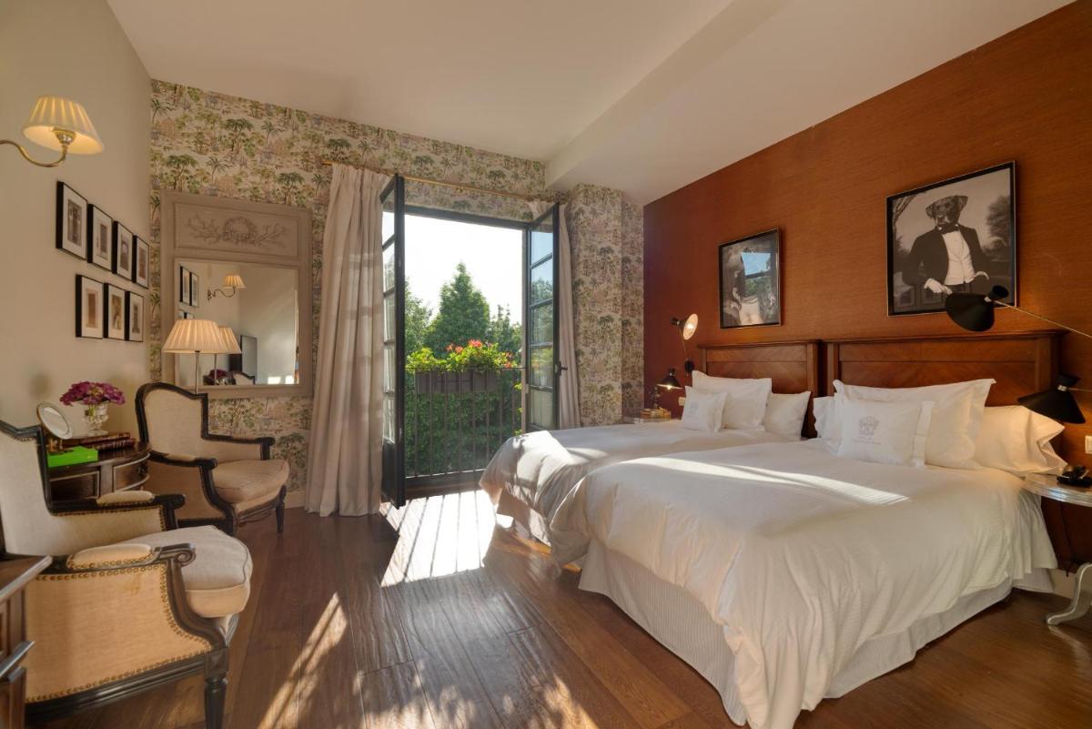 Cama o camas de una habitación en A Quinta Da Auga Hotel Spa Relais & Chateaux