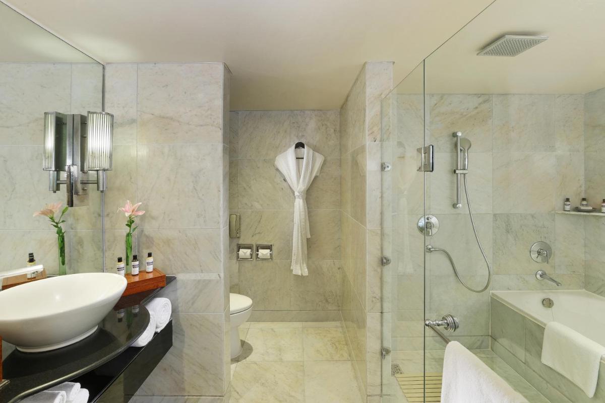 a bathroom with a shower and a sink and a toilet at Hyatt Regency Delhi in New Delhi a bathroom with a shower and a sink and a toilet at Hyatt Regency Delhi in New Delhi