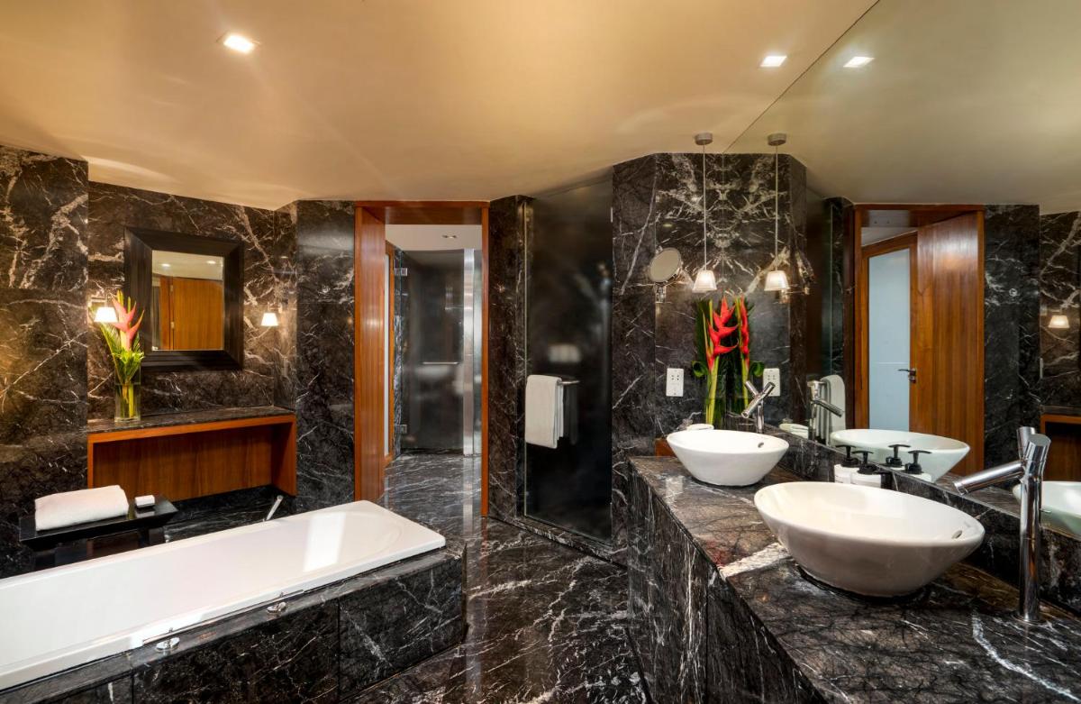 a bathroom with two sinks and a tub at InterContinental Marine Drive Mumbai by IHG in Mumbai