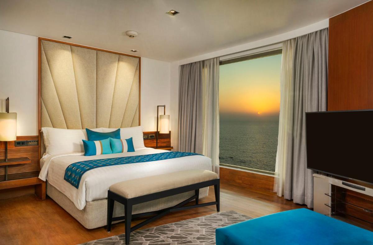a hotel room with a bed and a large window at InterContinental Marine Drive Mumbai by IHG in Mumbai