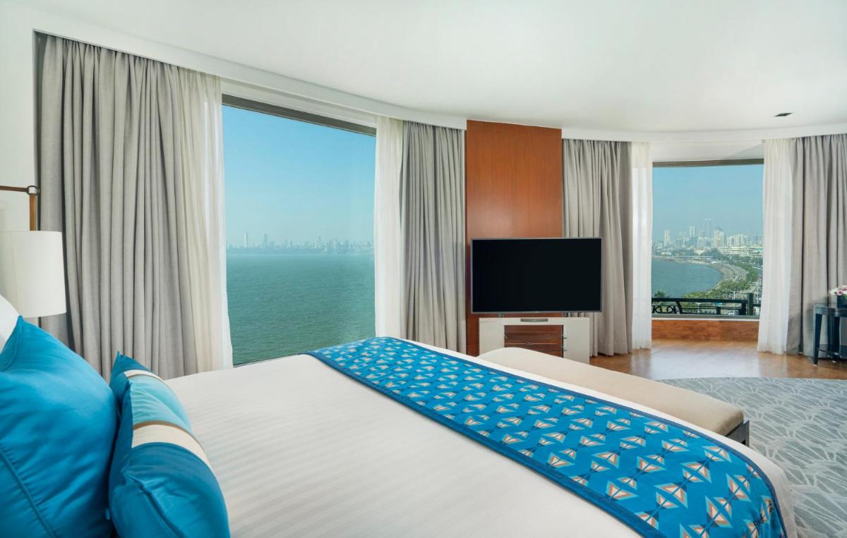 a bedroom with a large bed with a view of the ocean at InterContinental Marine Drive Mumbai by IHG in Mumbai