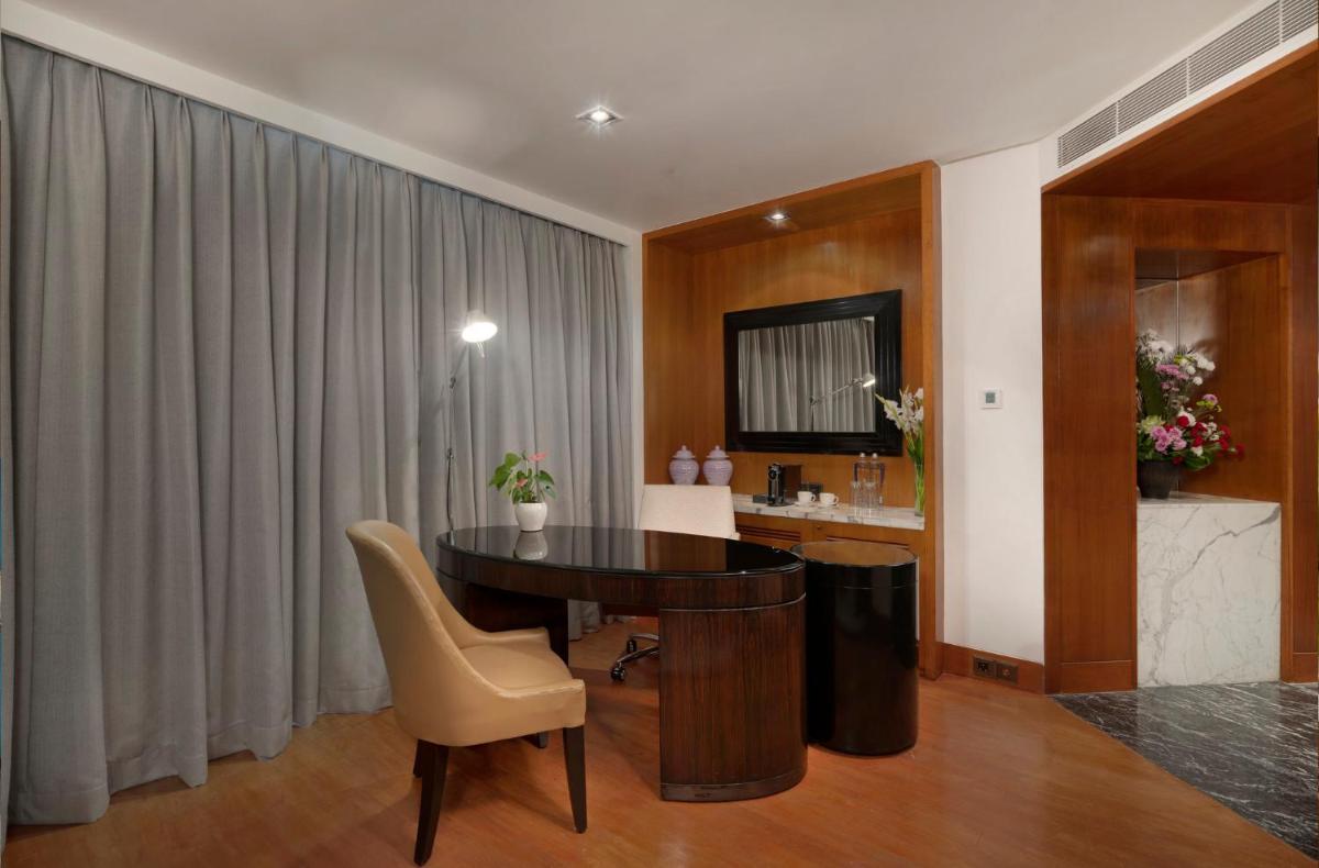 a living room with a table and a chair at InterContinental Marine Drive Mumbai by IHG in Mumbai