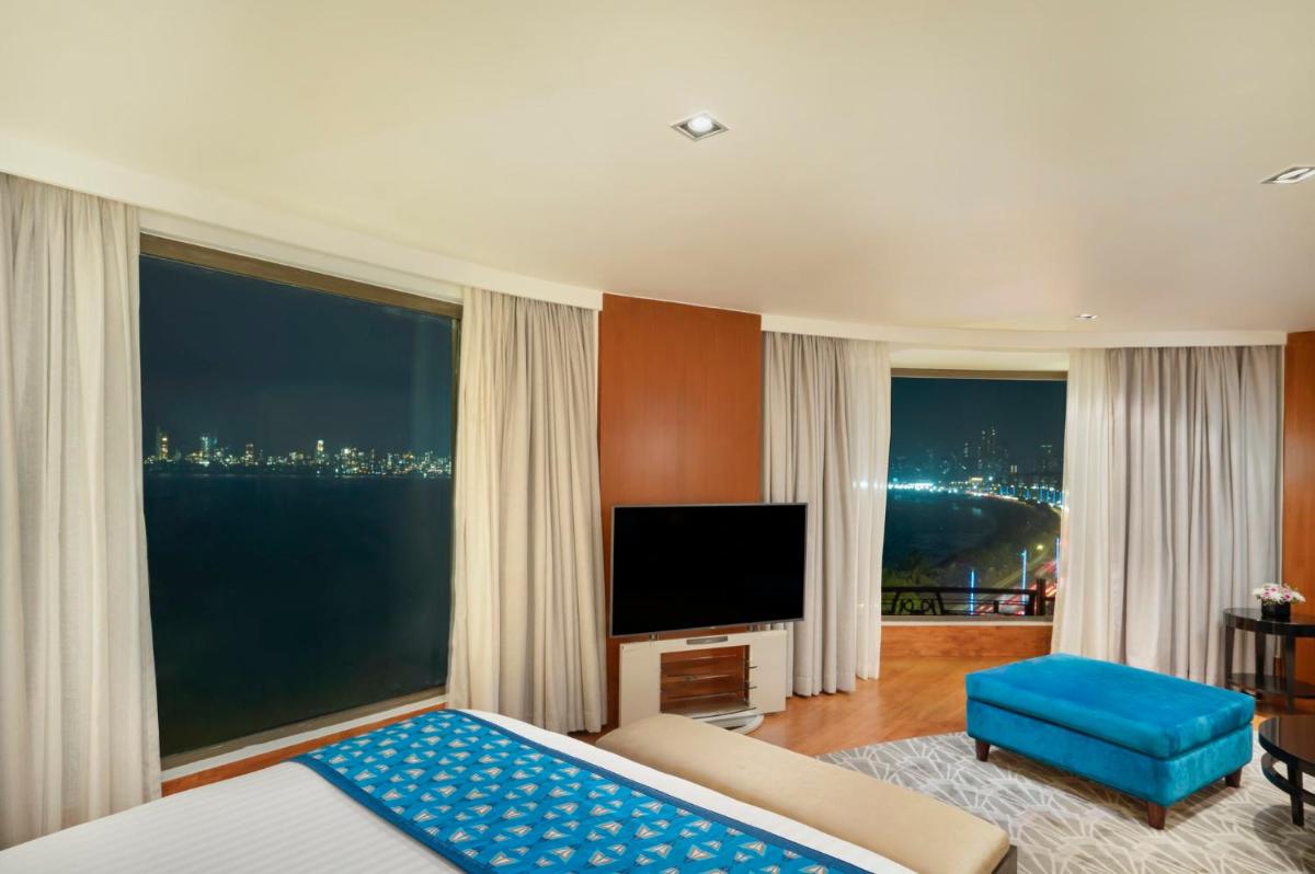 a bedroom with a bed and a large window at InterContinental Marine Drive Mumbai by IHG in Mumbai